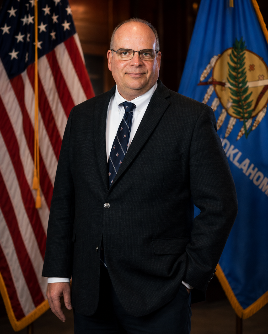 Professional portrait of Frank M. Wirth with the United States and Oklahoma flags